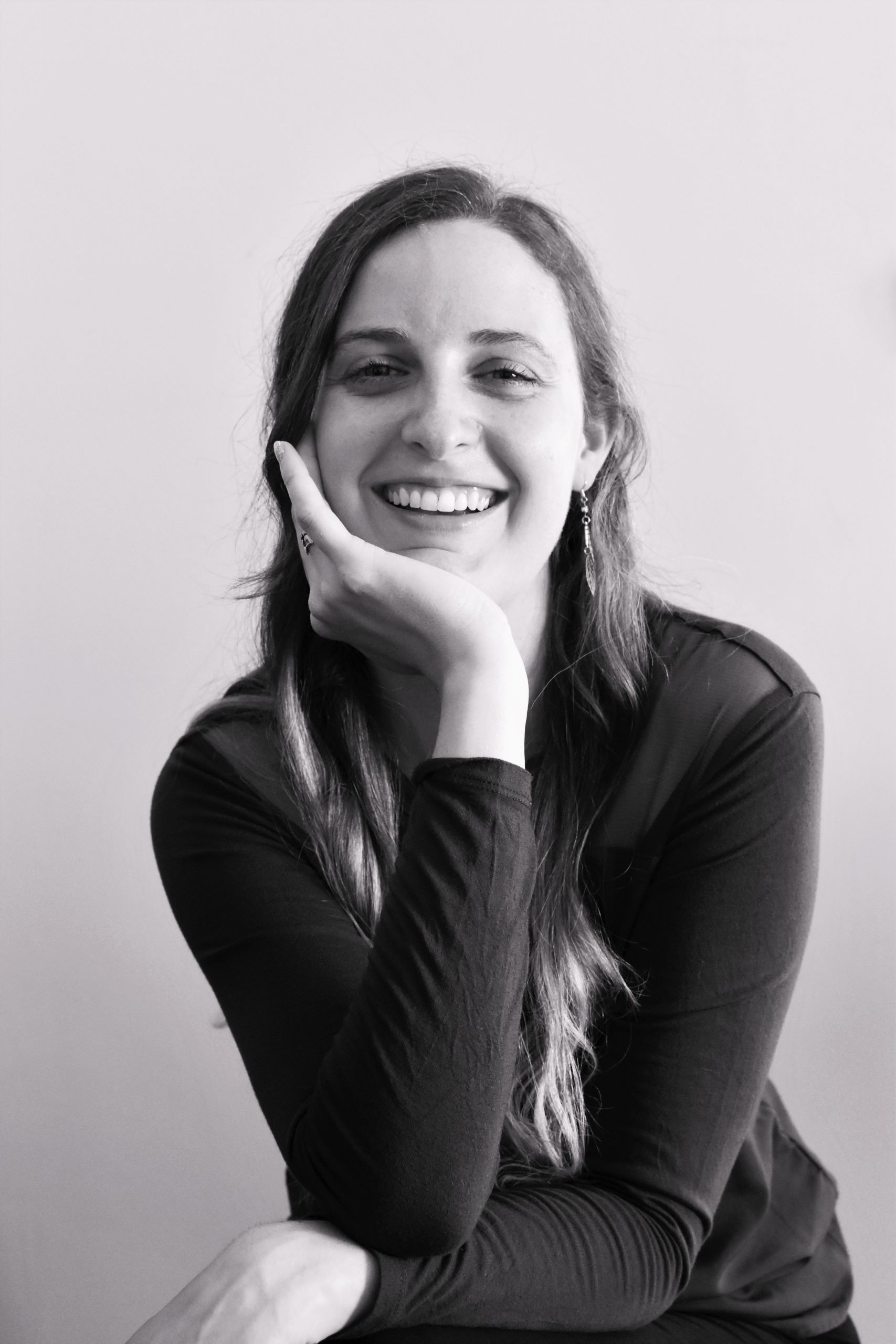 Katelyn is on black and white photo in good mood with huge smile