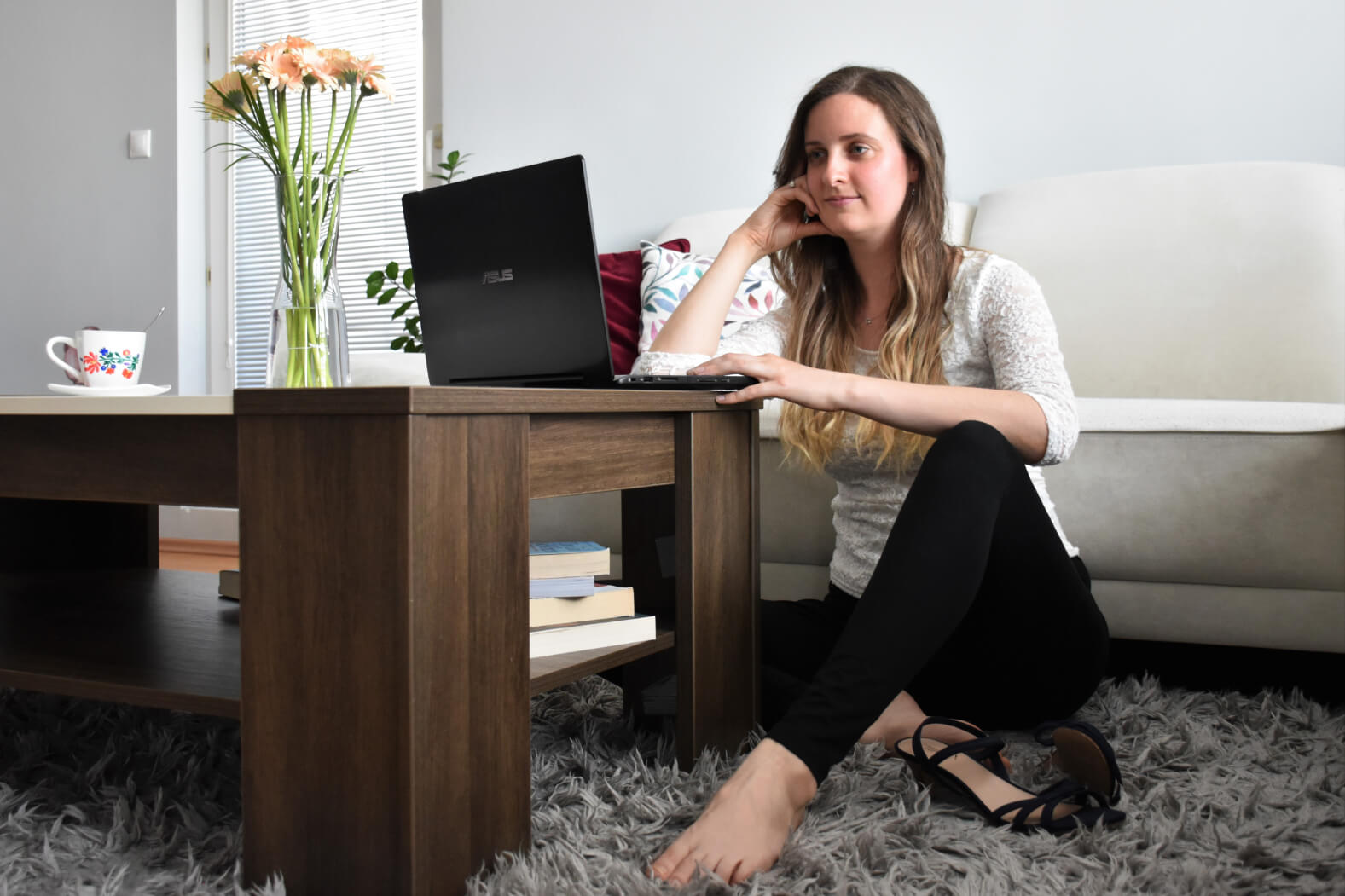 Katalyna work on her notebook in living room