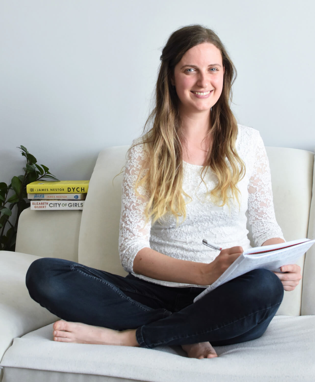 Katelyn is sitting on the couch and making notes